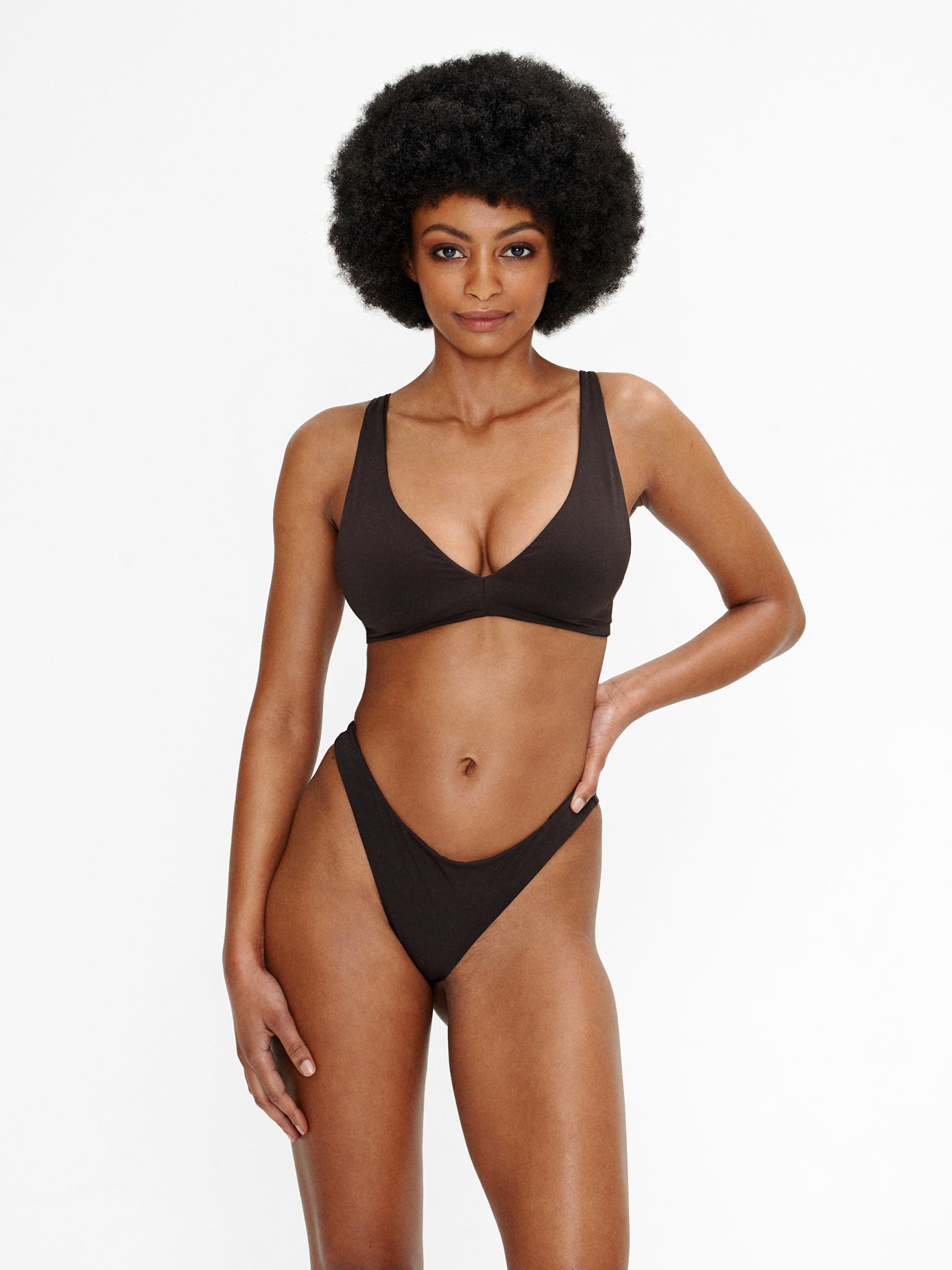 Model wearing the Kaiserin Emmy Top in coffee, featuring a smooth, double layered bikini design with adjustable straps and a tie back for a supportive, comfortable fit.