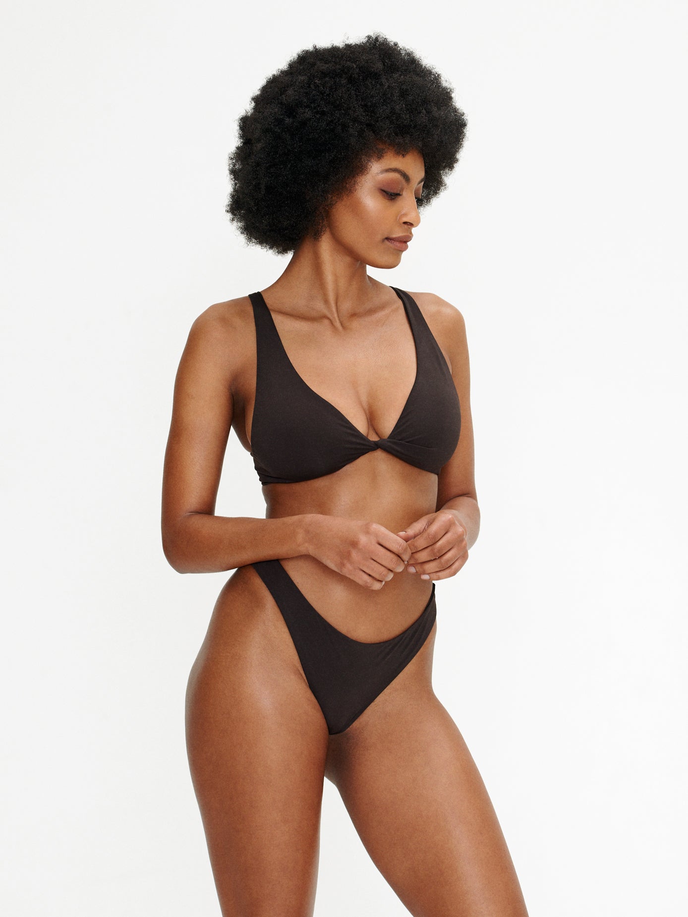 Model wearing Kaiserin Dez Bottom – Coffee, a seamless brown bikini bottom with a mid-rise fit and high cut leg, paired with a matching bikini top for a minimal, sculpted look.